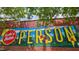 Motivational mural on a brick building, promoting positivity and community at 1000 Norris St, Raleigh, NC 27604