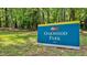 Oakwood Park sign surrounded by lush greenery, located in a serene park setting at 1000 Norris St, Raleigh, NC 27604