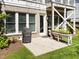 Brick patio under the deck has a grill and a planter box with greenery at 1000 Norris St, Raleigh, NC 27604