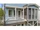 Close-up of the screened porch featuring white pillars and railing on a blue house at 1000 Norris St, Raleigh, NC 27604