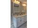 Double vanity bathroom with white cabinets and marble countertops at 1014 E Jones St, Raleigh, NC 27601