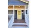 Home exterior with yellow door and covered porch at 1014 E Jones St, Raleigh, NC 27601