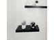 Stylish bathroom decor featuring floating shelves, decorative accents, and fresh towels at 103 Cimmaron Ct, Cary, NC 27511