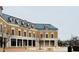 Commercial building with brick facade, white columns, and a prominent sign, surrounded by a paved plaza at 103 Cimmaron Ct, Cary, NC 27511