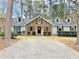 Brick and gray sided home with a large front yard and driveway at 103 Cimmaron Ct, Cary, NC 27511