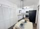 Bright kitchen featuring white cabinets, stainless steel appliances, and a nearby dining area at 103 Cimmaron Ct, Cary, NC 27511