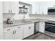 Modern white kitchen with granite countertops and stainless steel appliances at 103 Cimmaron Ct, Cary, NC 27511