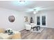 Bright living room with hardwood floors, white accent chairs, and French doors at 103 Cimmaron Ct, Cary, NC 27511