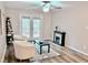 Bright living room features a ceiling fan, decorative fireplace, and access to the outdoor deck at 103 Cimmaron Ct, Cary, NC 27511