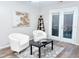 Living area with hardwood floors, white chairs, and a coffee table at 103 Cimmaron Ct, Cary, NC 27511
