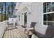 Front porch with black door and wicker chairs at 1035 W Murray Ave, Durham, NC 27704