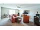 Spacious bonus room with leather furniture and a large TV at 1206 Newton Dr., Mebane, NC 27302