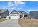 Brick ranch home with a two-car garage and landscaped front yard at 1206 Newton Dr., Mebane, NC 27302