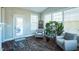 Bright sunroom with hardwood floors, comfy chairs, and plenty of plants at 1206 Newton Dr., Mebane, NC 27302