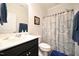 Clean bathroom featuring a black vanity, neutral colored walls, and tiled flooring at 125 Canary Ct. Ct, Raleigh, NC 27610