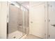 Modern bathroom with a tiled walk-in shower, glass door, and built-in bench at 125 Canary Ct. Ct, Raleigh, NC 27610