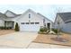 Landscaped lawn, a two-car garage, and a lovely front exterior define this quaint home at 125 Canary Ct. Ct, Raleigh, NC 27610