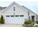 Charming home featuring a two-car garage, stone accents, neutral siding, and well-manicured landscaping at 125 Canary Ct. Ct, Raleigh, NC 27610