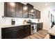 Spacious kitchen with stainless steel appliances, gas range, granite counters and dark cabinets at 125 Canary Ct. Ct, Raleigh, NC 27610