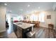 Open kitchen with island and granite countertop connecting to a dining and living room at 125 Canary Ct. Ct, Raleigh, NC 27610