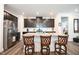 Modern kitchen island with granite countertops, dark cabinetry, stainless appliances and hardwood flooring at 125 Canary Ct. Ct, Raleigh, NC 27610