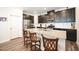 Kitchen island with granite counters, stainless appliances and dark cabinets and hardwood flooring at 125 Canary Ct. Ct, Raleigh, NC 27610