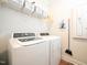 Bright laundry room featuring a front load washer, a front load dryer and storage shelving at 125 Canary Ct. Ct, Raleigh, NC 27610