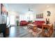 Bright living room featuring neutral walls, red couches, and modern ceiling fan at 125 Canary Ct. Ct, Raleigh, NC 27610