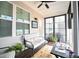 Cozy screened-in porch with comfortable seating, ceiling fan, and relaxing backyard view at 125 Canary Ct. Ct, Raleigh, NC 27610