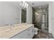 Bathroom with double vanity, marble countertops, and a large shower at 1300 St Marys St # 404, Raleigh, NC 27605
