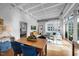 Bright dining area with wood table and blue chairs, open to living room at 1300 St Marys St # 404, Raleigh, NC 27605