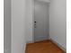 Simple entryway with hardwood floors and a grey door at 1300 St Marys St # 404, Raleigh, NC 27605