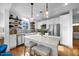 Modern kitchen with white cabinets and a large island at 1300 St Marys St # 404, Raleigh, NC 27605