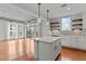 Open concept kitchen with island and hardwood floors at 1300 St Marys St # 404, Raleigh, NC 27605