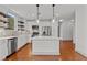 Modern kitchen with island and hardwood floors at 1300 St Marys St # 404, Raleigh, NC 27605