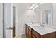 Bathroom featuring a double sink vanity, large mirror, and modern lighting at 1400 Basley St, Wake Forest, NC 27587