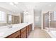 Bathroom with a large double sink vanity, tiled shower, and a soaking tub at 1400 Basley St, Wake Forest, NC 27587
