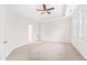 Bright primary bedroom with a tray ceiling, ceiling fan, and neutral carpeting at 1400 Basley St, Wake Forest, NC 27587