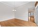 Inviting dining area featuring hardwood floors, chandelier, and wainscoting details at 1400 Basley St, Wake Forest, NC 27587