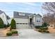 Charming home with manicured landscaping, stone accents, and a two-car garage at 1400 Basley St, Wake Forest, NC 27587