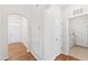 Inviting hallway showcasing beautiful hardwood floors and a glimpse of the laundry room at 1400 Basley St, Wake Forest, NC 27587