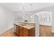 An open kitchen features granite countertops and stainless steel appliances, seamlessly flowing into living spaces at 1400 Basley St, Wake Forest, NC 27587