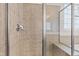 Close-up of the shower featuring tiled walls, a glass door, and a built-in bench at 1400 Basley St, Wake Forest, NC 27587
