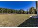 Large backyard with grassy area and a patio at 16 Sourgum Ct Ct, Zebulon, NC 27597