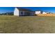 Large backyard with grassy lawn, white house, and wooden fence at 16 Sourgum Ct Ct, Zebulon, NC 27597