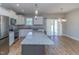Granite kitchen island, white cabinets, stainless steel appliances at 16 Sourgum Ct Ct, Zebulon, NC 27597