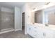 Bathroom boasts double vanity, tiled shower, and neutral color palette at 1701 Drayton Hall Ln, Sanford, NC 27330