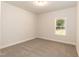 Serene bedroom with neutral carpeting, a window bringing in natural light, and a simple ceiling light at 1701 Drayton Hall Ln, Sanford, NC 27330