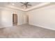 Spacious bedroom featuring a tray ceiling, ceiling fan, plush carpet, and neutral paint at 1701 Drayton Hall Ln, Sanford, NC 27330