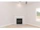 Marble fireplace with mantle, ceiling fan, wood-look flooring, and natural light at 1701 Drayton Hall Ln, Sanford, NC 27330